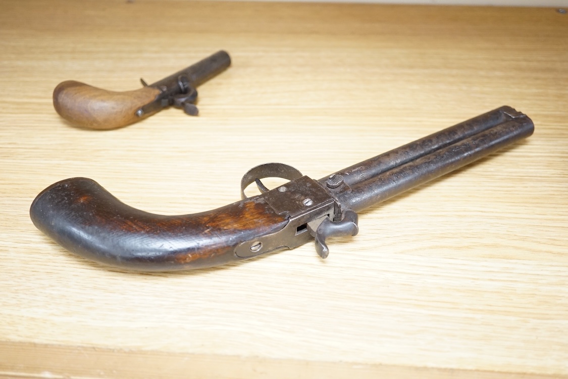 A boxlock percussion pocket pistol with Damascus twist turn off barrel, liege proofs, rounded wooden grip replaced, together with an ‘over and under’ boxlock percussion pistol